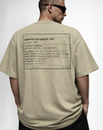 Man wearing a beige t-shirt with text on the back, standing against a plain background